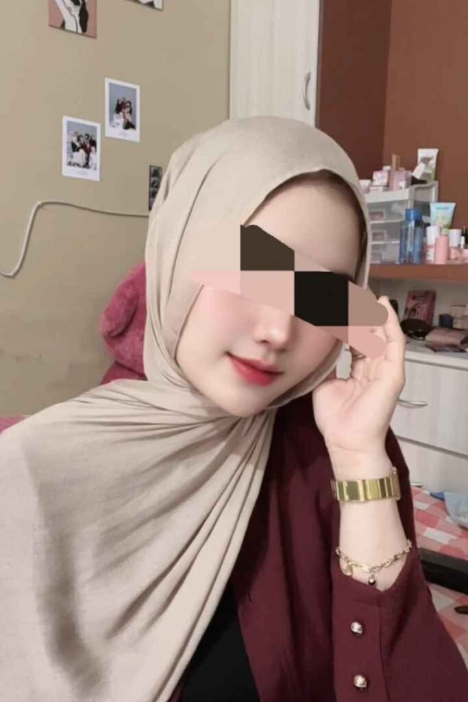 Malay woman in hijab, gold watch. Amina, local KL escort.