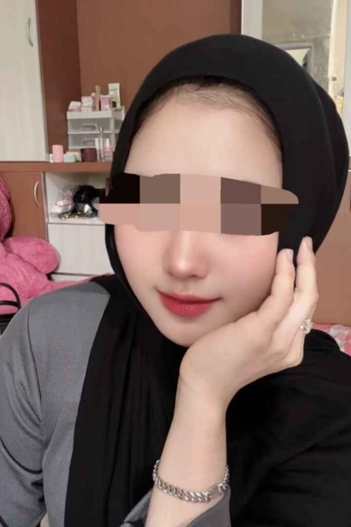 Amina, a Malay woman wearing a hijab, offering incall/outcall services in KL.