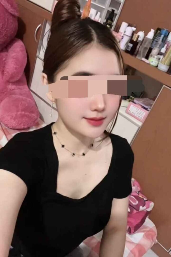 Amina, a 22-year-old Malay woman with a bun hairstyle wearing a black top.