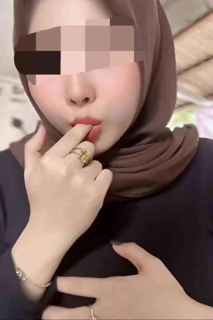 22yo Zana, sensual Malay escort KL, wearing a hijab and rings.