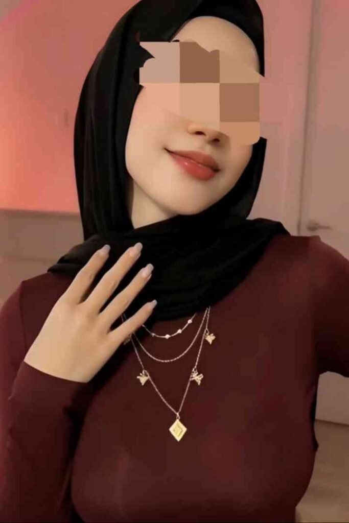 Zana, a 22yo Malay woman in a hijab and maroon top, wearing a layered necklace.